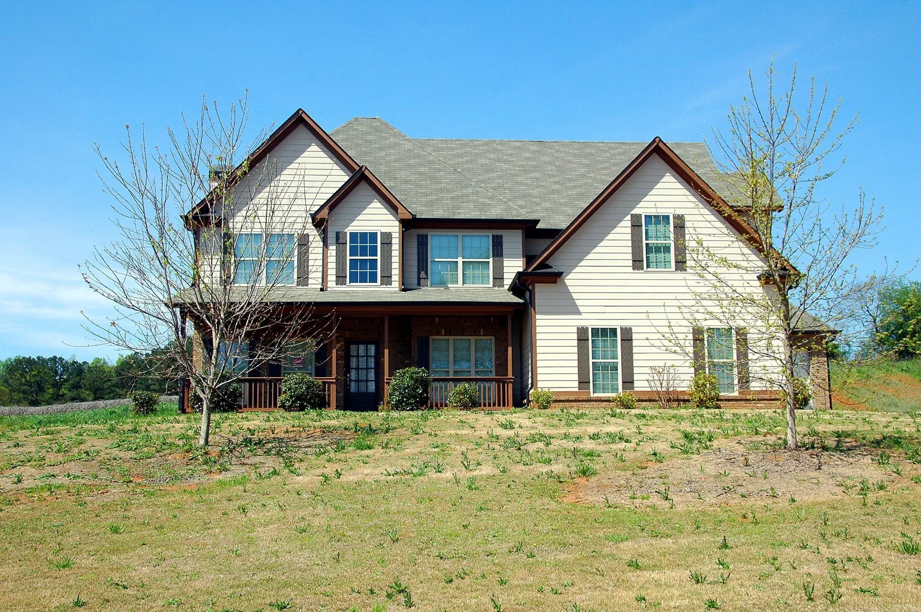 A detached house with a broad pitched roof and front lawn